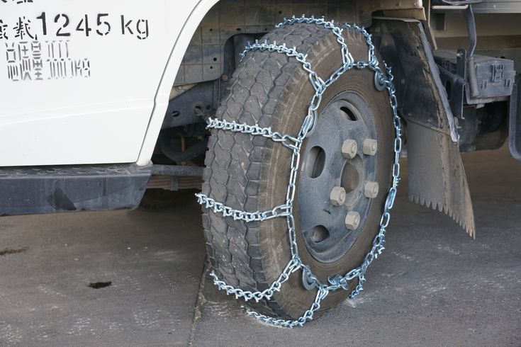 Truck tire fitted with snow chains for traction